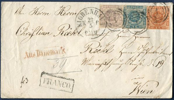 Envelope from Copenhagen 23 May 1858-65 to Vienna, Austria. Prepaid with 16 sk. 1857, 2 sk. 1855 dotted spandrels and 4 sk. 1858 wavy-line issue, all full margined stamps tied by numeral 1 and datestamp - KIØBENHAVN KB 24/5 9-10M – and boxed FRANCO and red – Aus Dänemark – struck on front. From Danish rayon 2 – 9 sk. – to Germany-Austrian postal union rayon 3 – 13 sk., total 22 sk. postage. Letter’s sent to Vienna, Austria are far scarcer than other 22 sk. rates to Germany.