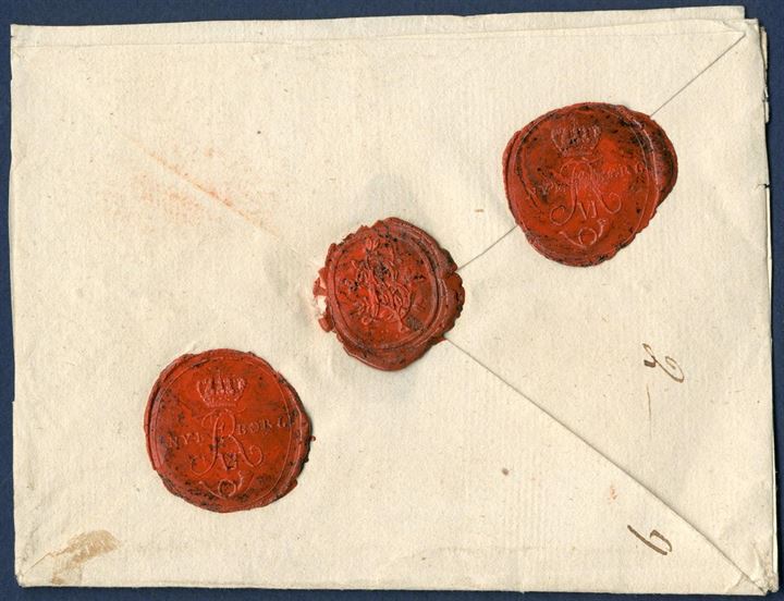 Money Letter from lottery agent Bruun in Nyborg sent between 1 Feb – 6 Aug 1813 to Bie, Copenhagen. Contained - Heruid 85 Rbd: 12ß D: C: - and royal insignia Fr.VI, and with closed with three red wax seals, two post office seals – NYBORG FR VI – and Bruuns own wax seal. Postage noted on reverse – 2 – 9 – list no. 2 and postage 9 Rbß for 1-100 Rbdlr.: 9 Rbß. Description can be found on Toke Nørby’s website.